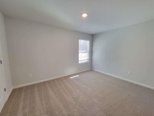 unfurnished room featuring carpet