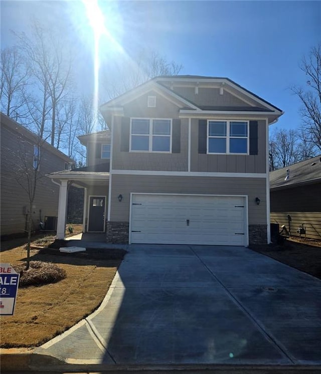 view of property featuring covered porch and a garage