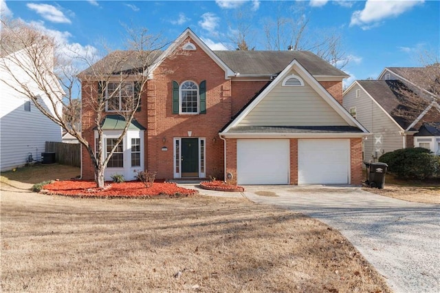 colonial house with a front yard, concrete driveway, brick siding, and an attached garage