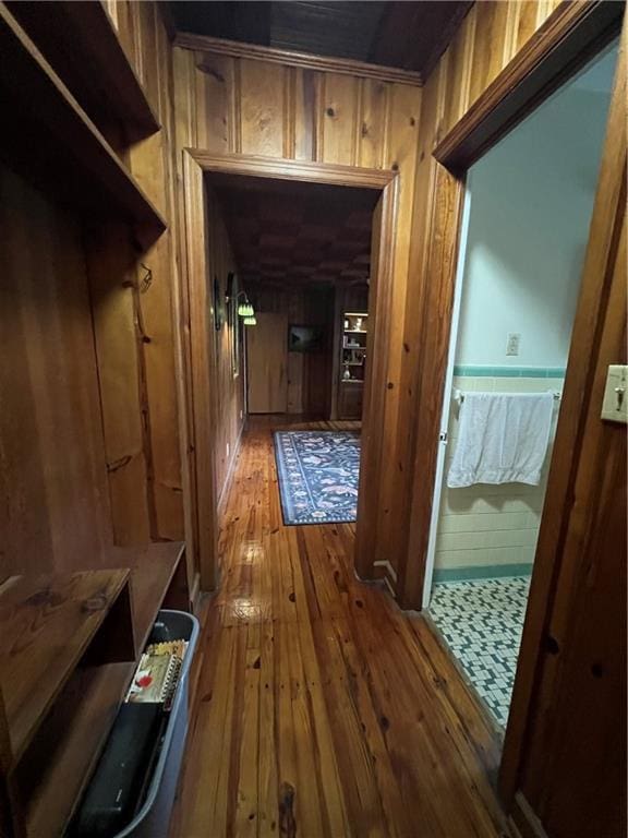 hall featuring hardwood / wood-style flooring and wood walls