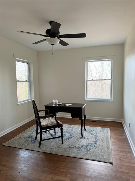 office area with visible vents, a ceiling fan, baseboards, and wood finished floors