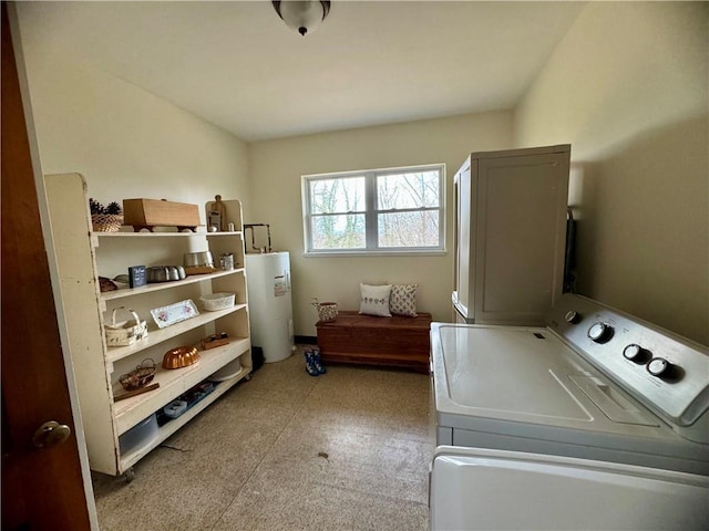 washroom with laundry area, water heater, and washer and clothes dryer