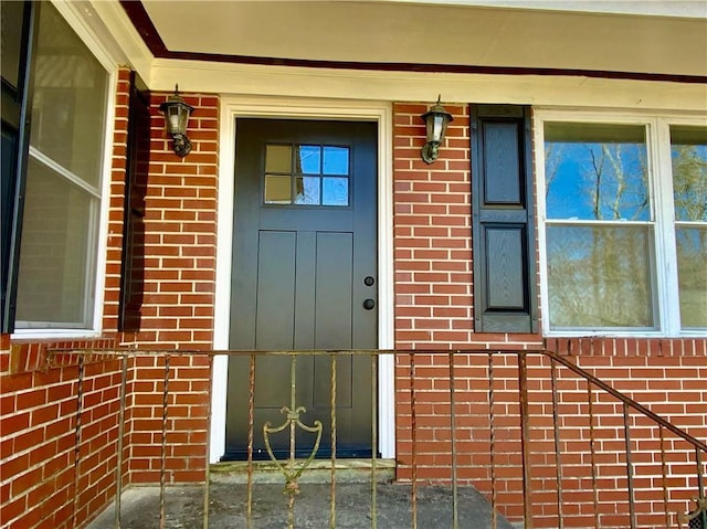 doorway to property with brick siding