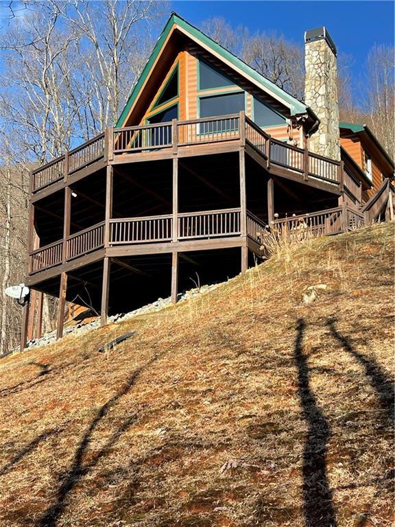 71 Hidden Valley Dr S, Ellijay, GA 30536 - back of property with a deck and a chimney