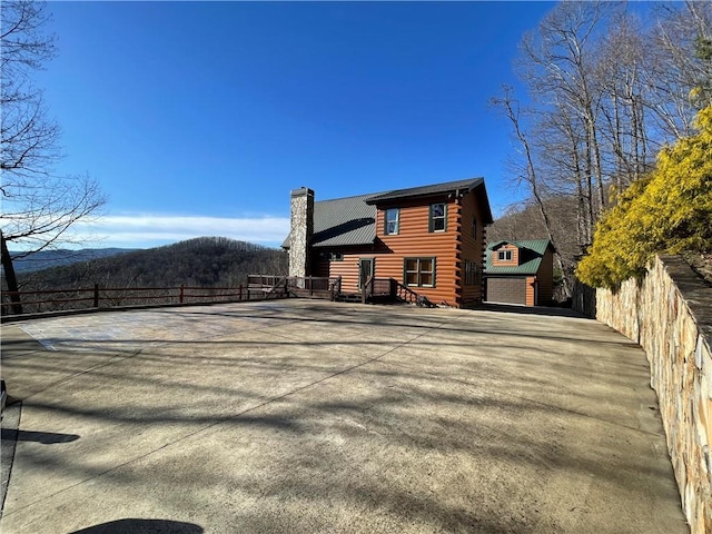 71 Hidden Valley Dr S, Ellijay, GA 30536 - back of property featuring log siding, a chimney, a mountain view, and an outdoor structure