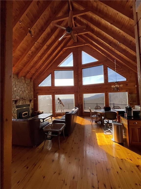71 Hidden Valley Dr S, Ellijay, GA 30536 - living room featuring hardwood / wood-style floors, a wood ceiling with exposed beams, high vaulted ceiling, and a chandelier