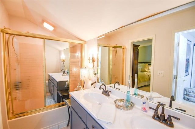 bathroom featuring vaulted ceiling, bath / shower combo with glass door, and vanity