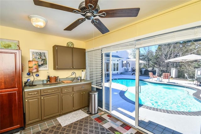 kitchen featuring ceiling fan and sink