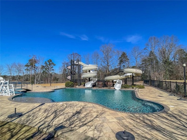 view of swimming pool with a patio and a water slide