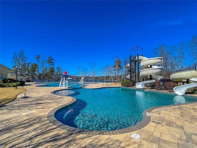 view of swimming pool featuring a patio area and a water slide