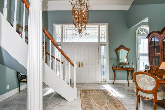 foyer entrance with a towering ceiling and an inviting chandelier