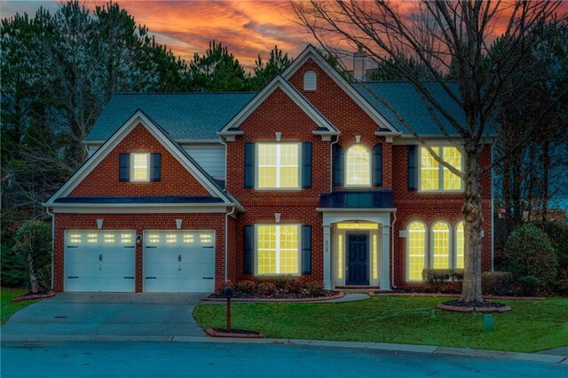 craftsman-style house with a garage and a lawn