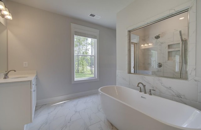 bathroom featuring shower with separate bathtub and vanity