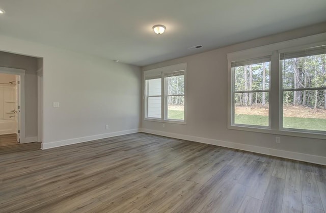 unfurnished room featuring hardwood / wood-style floors