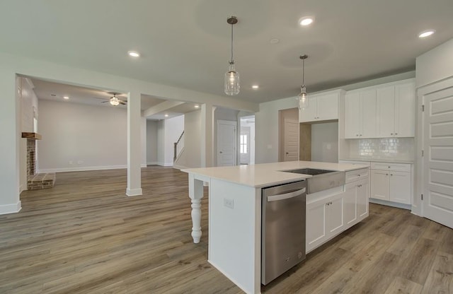 kitchen featuring backsplash, a center island, white cabinets, and light hardwood / wood-style floors