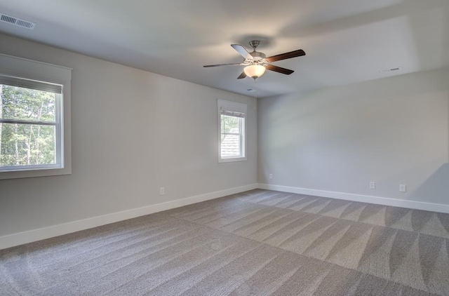 spare room with light carpet and ceiling fan