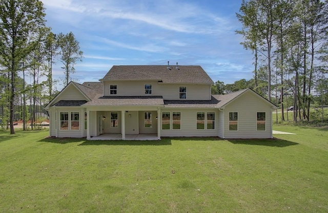 rear view of house with a patio area and a yard