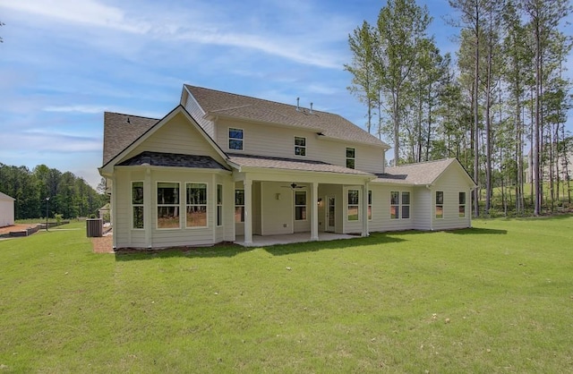 rear view of house with a patio area, a yard, and central air condition unit