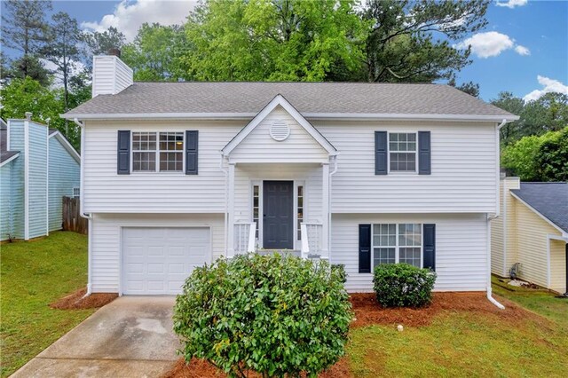 1645 Cobbs Creek Ln, Decatur, GA 30032 - split foyer home with driveway, a front lawn, an attached garage, and a chimney