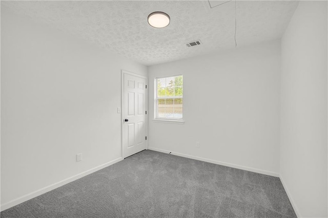 1645 Cobbs Creek Ln, Decatur, GA 30032 - carpeted spare room with attic access, a textured ceiling, and baseboards