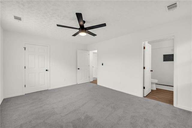 1645 Cobbs Creek Ln, Decatur, GA 30032 - unfurnished bedroom featuring carpet flooring, baseboards, ensuite bath, a textured ceiling, and a ceiling fan