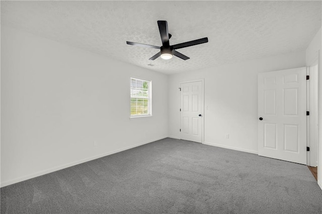 1645 Cobbs Creek Ln, Decatur, GA 30032 - unfurnished bedroom featuring a textured ceiling, baseboards, dark colored carpet, and ceiling fan