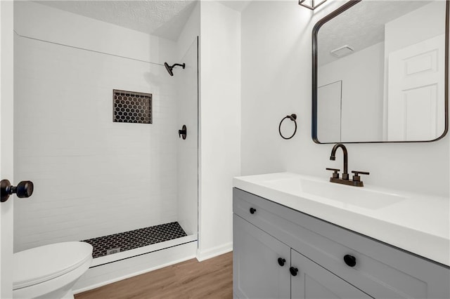 1645 Cobbs Creek Ln, Decatur, GA 30032 - full bath featuring a textured ceiling, a shower stall, wood finished floors, vanity, and toilet