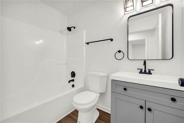 1645 Cobbs Creek Ln, Decatur, GA 30032 - full bath with wood finished floors, toilet, vanity, baseboards, and shower / washtub combination