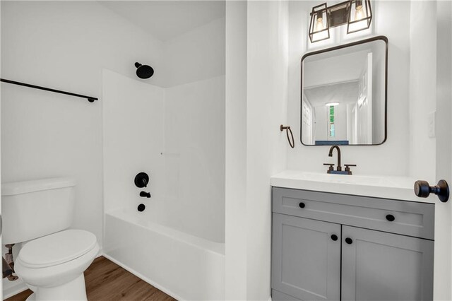 1645 Cobbs Creek Ln, Decatur, GA 30032 - bathroom featuring toilet, vanity, wood finished floors, and shower / tub combination