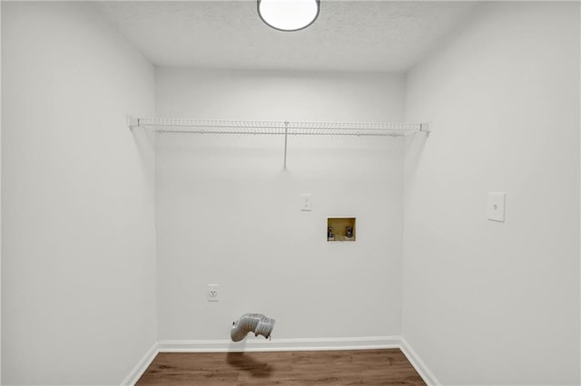 1645 Cobbs Creek Ln, Decatur, GA 30032 - clothes washing area with hookup for an electric dryer, washer hookup, wood finished floors, baseboards, and a textured ceiling