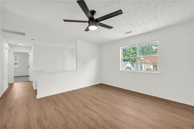 1645 Cobbs Creek Ln, Decatur, GA 30032 - spare room featuring a textured ceiling, wood finished floors, a ceiling fan, and baseboards