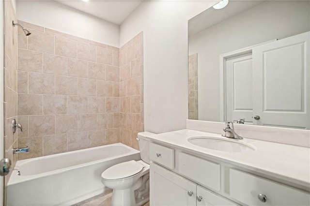 bathroom featuring toilet, vanity, and bathing tub / shower combination