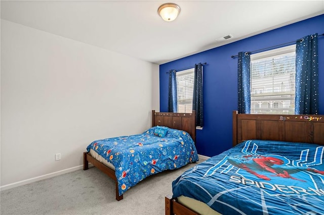 carpeted bedroom with baseboards and visible vents