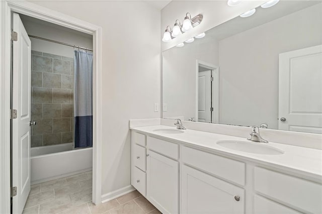 full bathroom with shower / tub combo, tile patterned floors, a sink, and double vanity