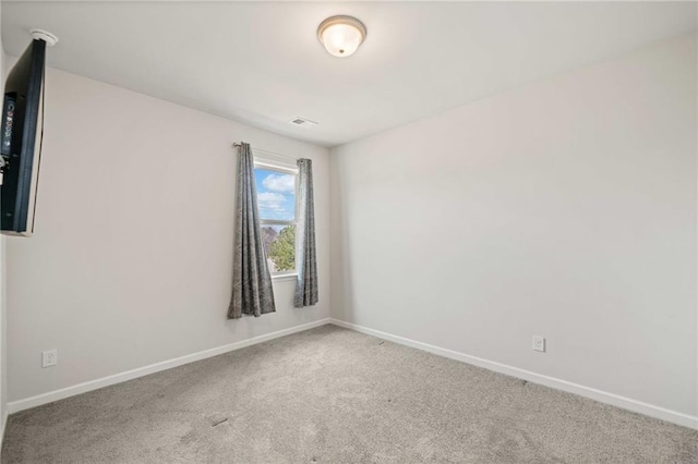 carpeted empty room with baseboards