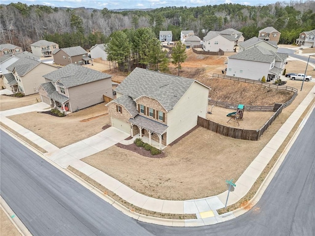 bird's eye view with a wooded view and a residential view