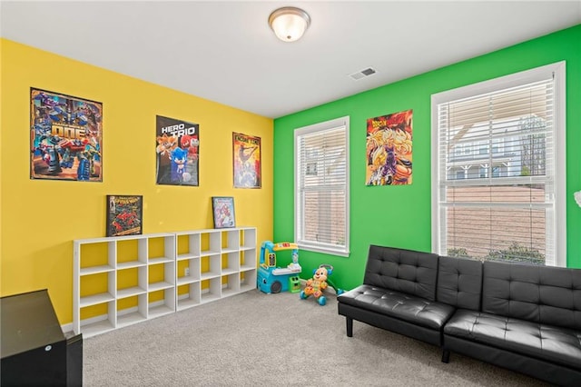 game room with a wealth of natural light, visible vents, and carpet