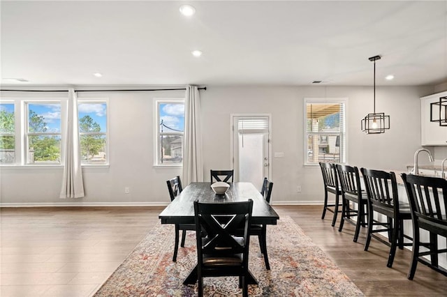 dining room featuring dark wood-style floors, a wealth of natural light, and recessed lighting