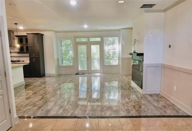 4590 River Stone Trl, Douglasville, GA 30135 - foyer with crown molding, inlaid floor details, healthy amount of natural light, wainscoting, and baseboards