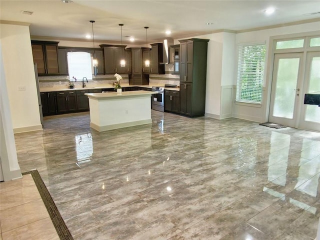 4590 River Stone Trl, Douglasville, GA 30135 - kitchen with stainless steel electric stove, light countertops, wall chimney exhaust hood, a kitchen island, and backsplash