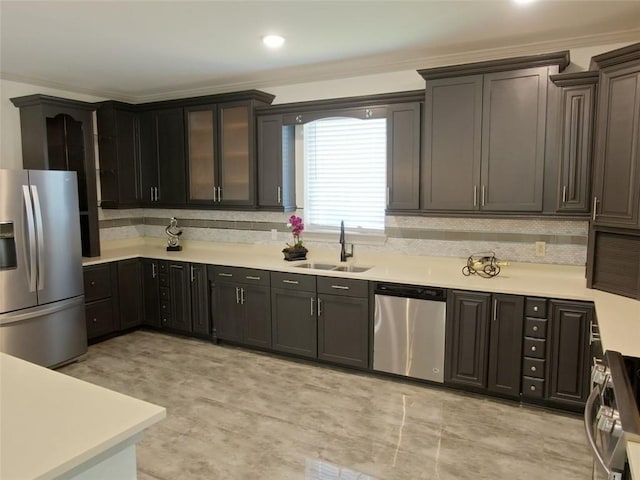 4590 River Stone Trl, Douglasville, GA 30135 - kitchen featuring appliances with stainless steel finishes, a sink, light countertops, crown molding, and tasteful backsplash