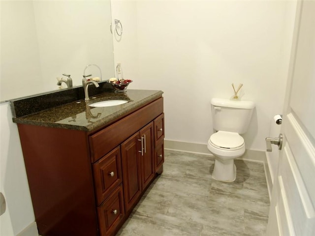 4590 River Stone Trl, Douglasville, GA 30135 - bathroom with vanity, toilet, and baseboards
