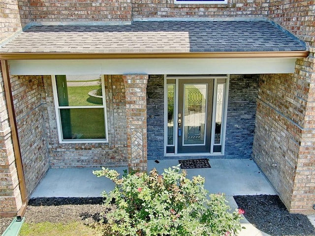 4590 River Stone Trl, Douglasville, GA 30135 - doorway to property featuring brick siding, roof with shingles, and covered porch