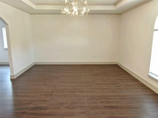 4590 River Stone Trl, Douglasville, GA 30135 - spare room with arched walkways, crown molding, a raised ceiling, a chandelier, and healthy amount of natural light