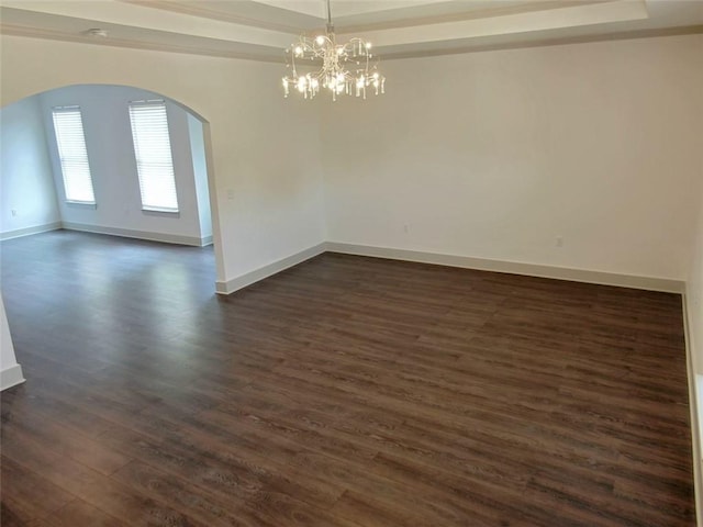4590 River Stone Trl, Douglasville, GA 30135 - spare room with arched walkways, dark wood-style flooring, a chandelier, and baseboards