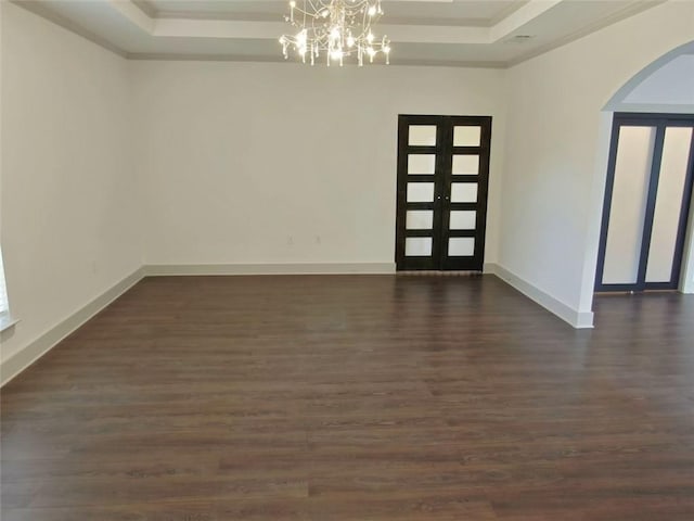 4590 River Stone Trl, Douglasville, GA 30135 - entrance foyer featuring a raised ceiling, a chandelier, arched walkways, ornamental molding, and dark wood-style flooring