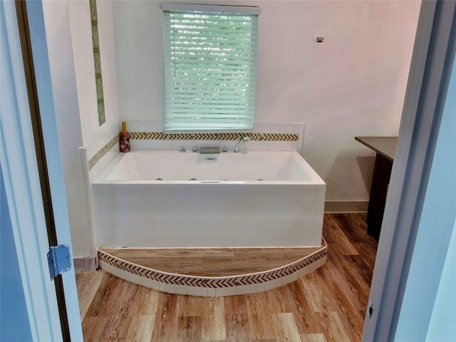 4590 River Stone Trl, Douglasville, GA 30135 - bathroom with a garden tub and wood finished floors