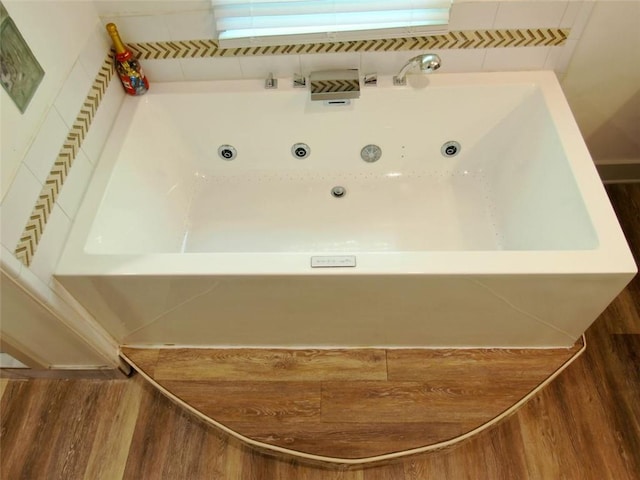 4590 River Stone Trl, Douglasville, GA 30135 - full bathroom featuring wood finished floors and a tub with jets