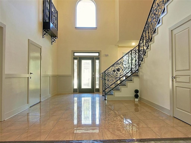 4590 River Stone Trl, Douglasville, GA 30135 - foyer entrance featuring a towering ceiling, stairs, baseboards, and light marble finish flooring