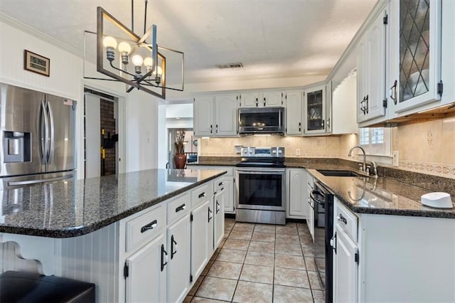 263 Mountainview Cir, Canton, GA 30115 - kitchen featuring stainless steel appliances, a chandelier, glass insert cabinets, decorative backsplash, and white cabinets
